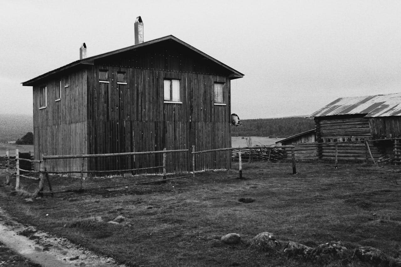 Treating a large wooden outbuilding with traditional Swedish black tar paint for a modern, rustic look.