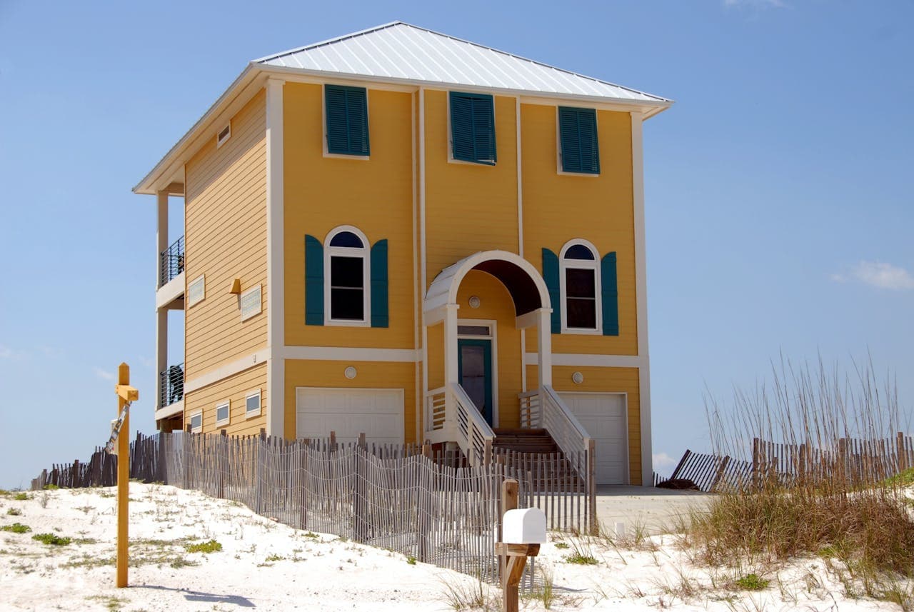 Applying specialized salt-resistant primer and high-gloss white finish to a seaside residence.