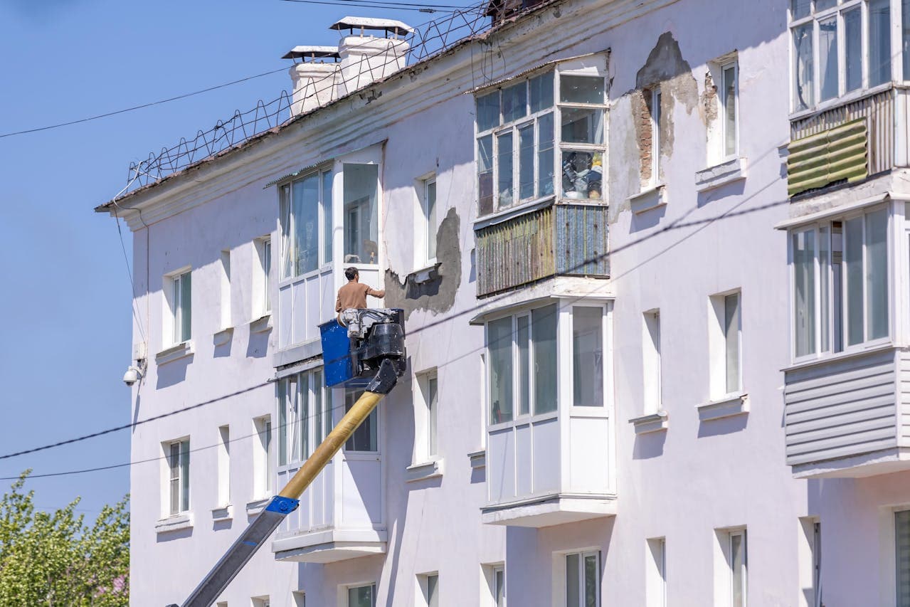 Detailed repair of rotted wooden sills and pulley systems for classic sash windows.